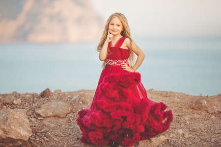 Child girl on the top of mountain with sea viewの写真素材