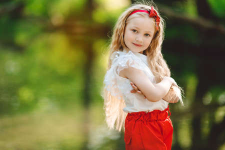 Beautiful little girl outdoors near riverの写真素材