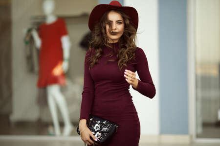 Beautiful elegant woman is wearing fashion autumn clothes with black bag, fall conceptの写真素材
