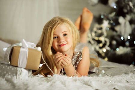 Portrair of pretty blonde girl is near decorated xmas treeの写真素材