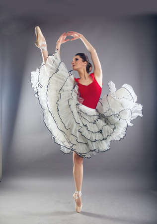 Beautiful woman ballet dancer in studioの写真素材