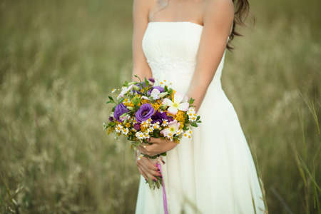 Wedding details, fashion bridal bouquet in hands of brideの写真素材