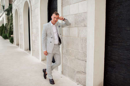 Handsome businessman is wearing white fashion costume. Montenegro bay.の写真素材