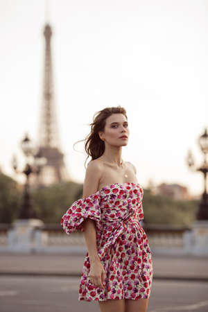 Beautiful girl is walking in Paris with Eiffel tower view , France, summer timeの写真素材