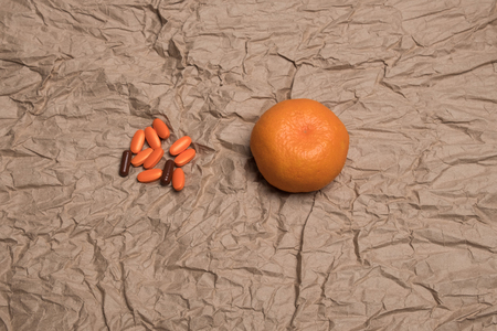 Tangerines and  pills. Mandarins and orange pills.の写真素材