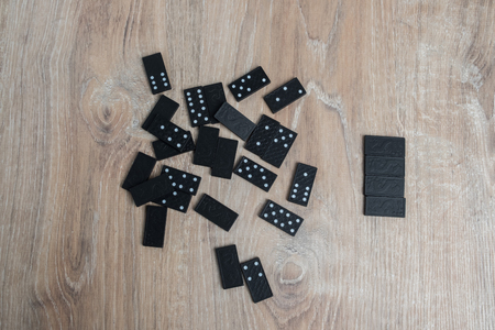 Dominoes on a wooden table. Parts of game of domino on wood.の写真素材