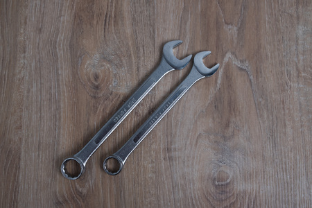 Set of wrenches studio image. Tool old wrenches on wooden background.の写真素材