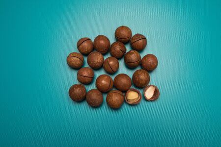 Macadamia nuts studio image. Nuts on a blue background. Macadamia symbol.の写真素材