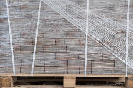 Building materials outdoors. Packed new building materials. New curbs for the road.