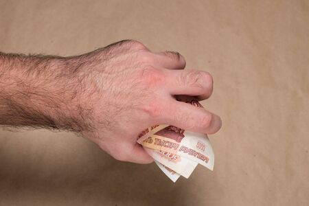 Male hand with russian money studio image. Man's hand holds Russian rubles. Male hand with money.