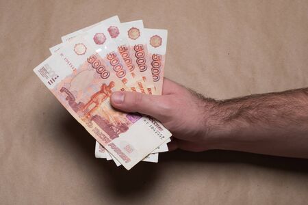 Male hand with russian money studio image. Man's hand holds Russian rubles. Male hand with money.