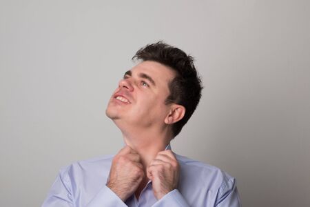 Attractive young man. Angry business man. Studio image of a tired man.の写真素材