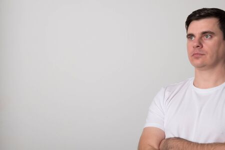 Positive young man. Pretty man in a white shirt.の写真素材