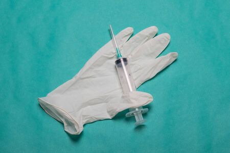 Surgical gloves with a syringe. Medical kit, gloves and syringe. Latex gloves and syringe.の写真素材