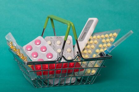Shopping cart with medicines. Studio image of a small medicine trolley with medicine.の写真素材