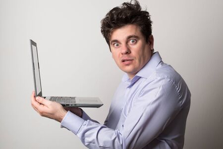 Man with a laptop. Young man works on the laptop remotely.