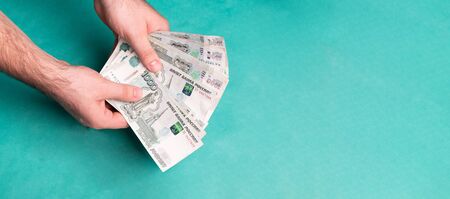 Man holds Russian money. Financial theme. Money in men's hands.