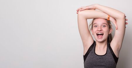 Funny beautiful sporty girl doing sport wearing sportswear. Banner with blank space for text.の写真素材