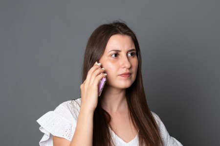 Young woman is talking on a cell phone.
