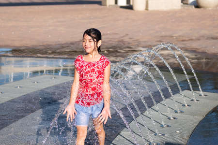 Kerch/Russia - June 27, 2020: Happy children laugh and splash in fountain in the summer park.のeditorial素材