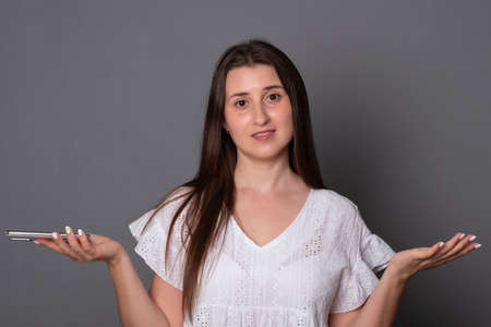 Young woman with telephone. Frustrated woman holding a mobile phone.