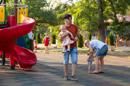 Kerch/Russia - June 29, 2020: Little children with their parents play in the playground.のeditorial素材