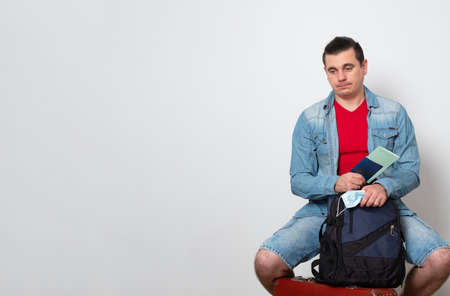 Sad tourist worried about coronavirus quarantine. COVID-19 impact in international tourism.