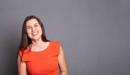 Cheerful smiling young woman. Beautiful woman is smiling. Banner copy space.の写真素材