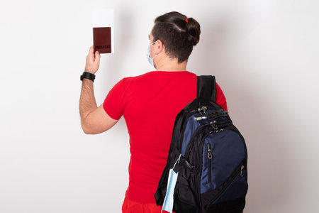 Happy young man going on summer vacation. Concept of covid-19, travelling and quarantine.