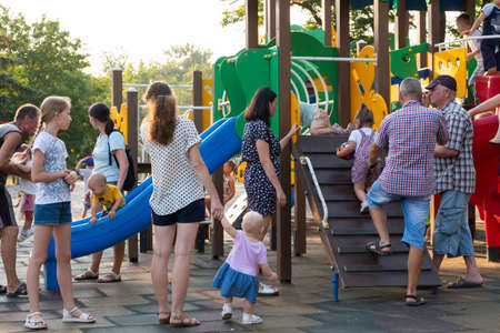 Little children with their parents play in playground. Family vacation in summer. Kerch, Russia - June 29, 2020のeditorial素材