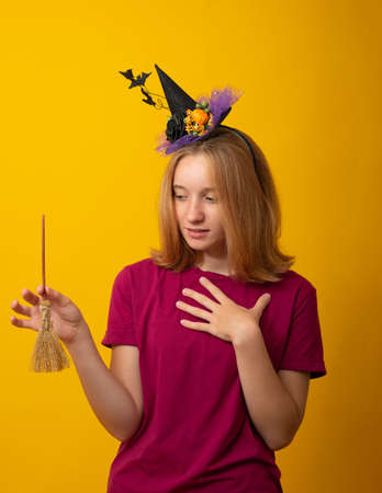 Cute girl dressed in halloween costume in studioの写真素材