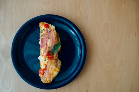 Sourdough bread topped with bacon and scrumble eggsの写真素材