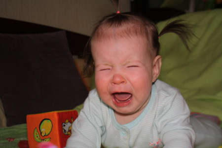 Baby crying on the couch