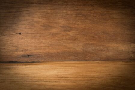Wooden board empty vintage table in front of perspective brown wood blur backgroundの写真素材