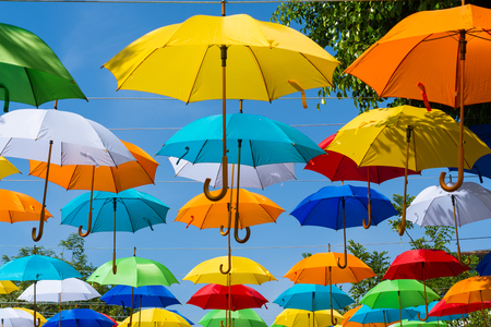 There are many colorful umbrellas on the street.の写真素材