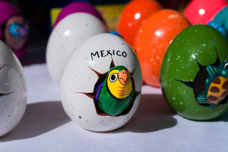 Mexican handicraft, parakeet comes out of the egg.