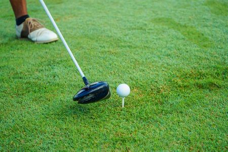 The foot, the stick aimed at the golf ball.の写真素材