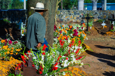 A gardener arranges the flowers in the pantheon on the day of the dead.のeditorial素材