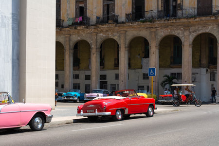 Havana, Cuba - August 25 2018: A classic pink car is driving down a street in Old Havana.のeditorial素材
