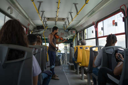 Guadalajara Jalisco Mexico - August 25, 2020: Young man is playing his violin on a public transport in Guadalajara.のeditorial素材