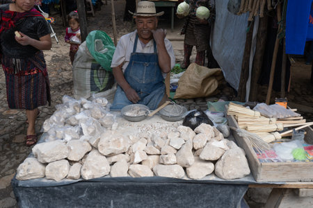 Chichicastenango, Guatemala - October 10, 2019: The gentleman is selling stones in the Chichicastenango market.のeditorial素材