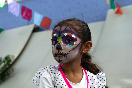 Guadalajara Jalisco - November 03, 2019: The girl is looking out of the corner of her eye with her face made up on the day of the dead in Guadalajara.のeditorial素材