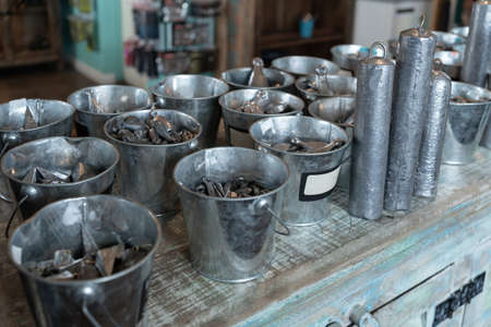 There are a lot of different lead fishing sinkers in the buckets.
