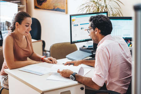 People working in an adviser's office with and without mask