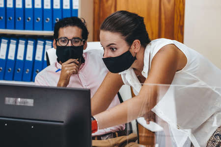 People working in an adviser's office with and without maskの写真素材