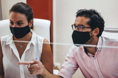 People working in an adviser's office with and without maskの写真素材