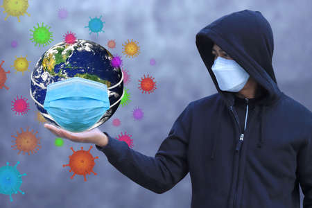 Man wearing a mask To prevent the virus Covid-19, Help protect the planet Earthの写真素材