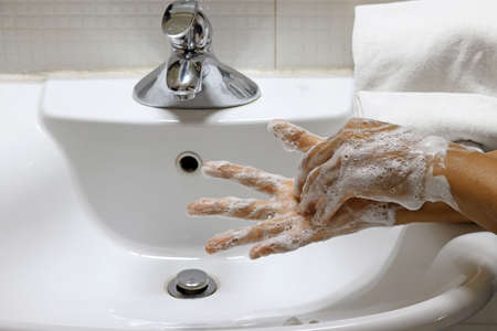Coronavirus pandemic prevention wash hands with soap warm water,concept To prevent the covid-19の写真素材