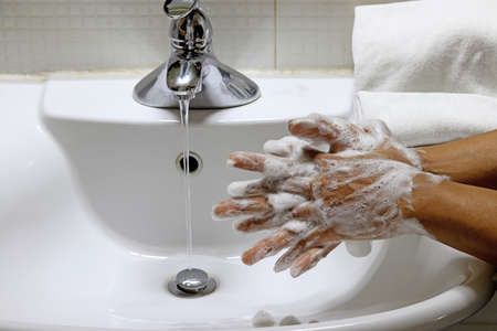 Coronavirus pandemic prevention wash hands with soap warm water,concept To prevent the covid-19の写真素材