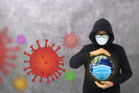 Man wearing a mask To prevent the virus Covid-19, Help protect the planet Earthの写真素材